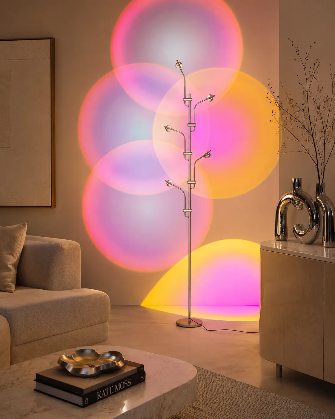 Halo projector casting pink and orange light around chrome decor