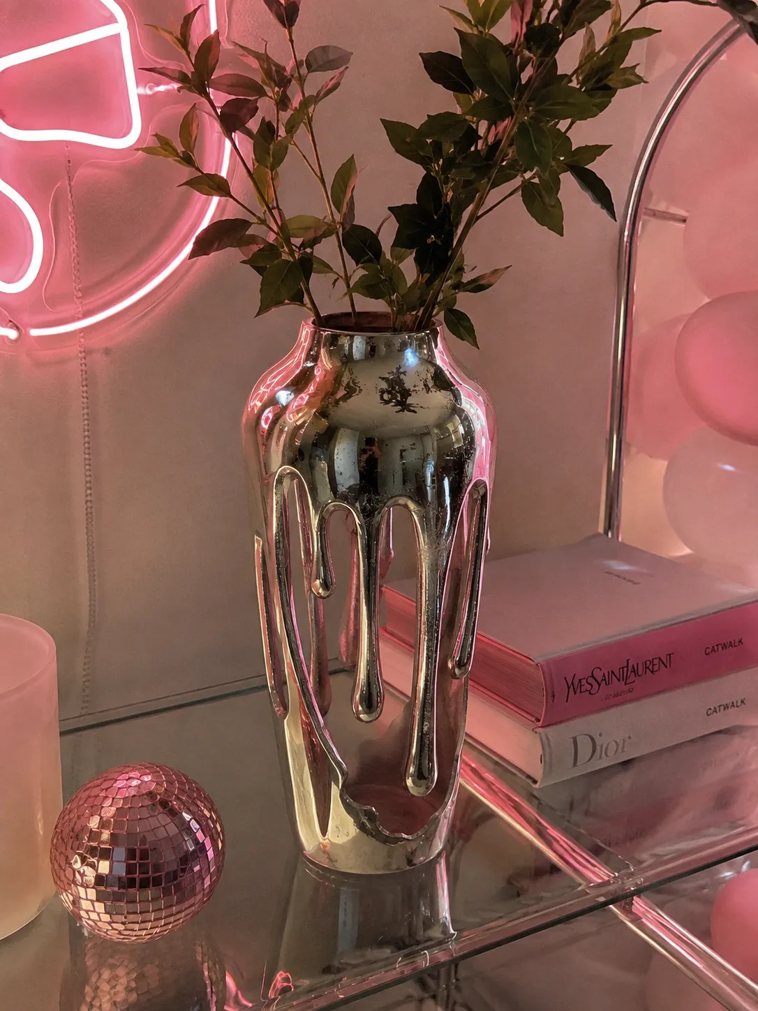 Chrome decor reflecting warm pink neon light
