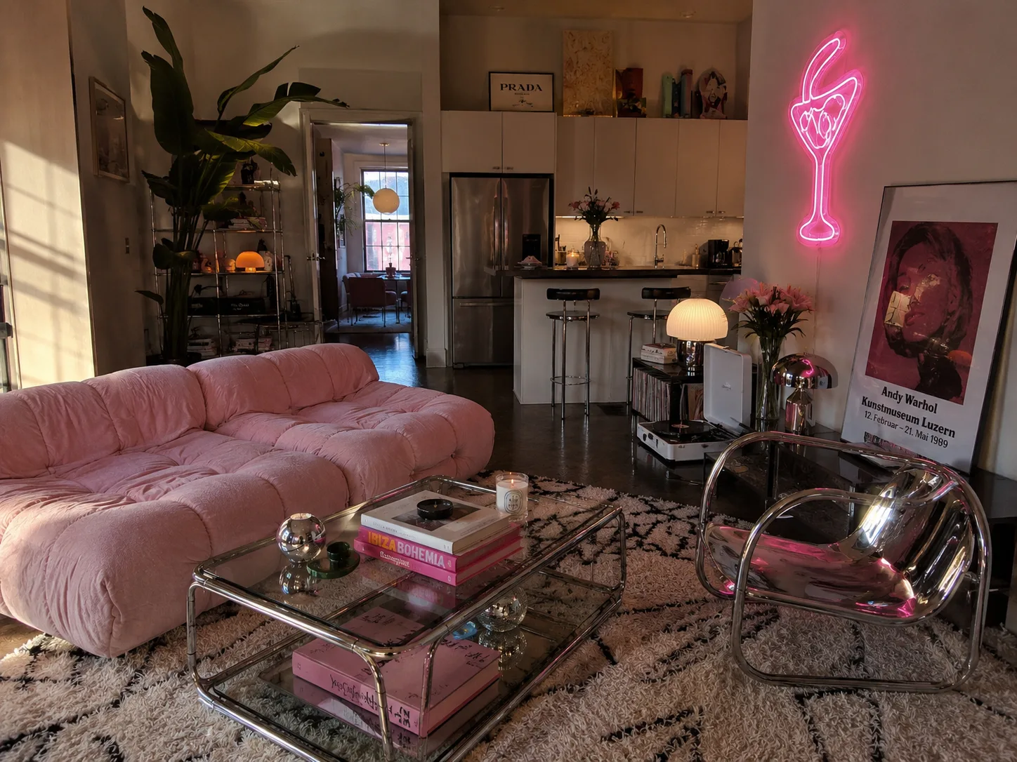 Pink retro inspired living room with chrome furniture and neon lighting