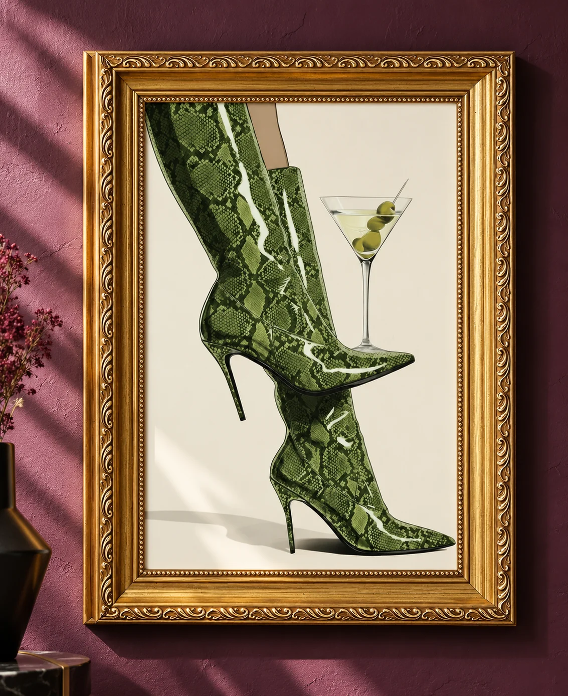 Ornate gold-framed print of green snakeskin boots and a martini on a plum wall.