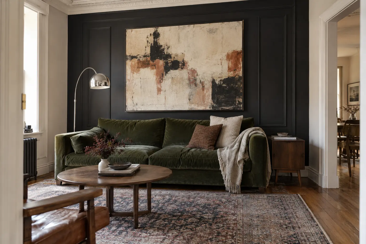 Black picture-frame molding accent wall behind a neutral sofa in a bright living room